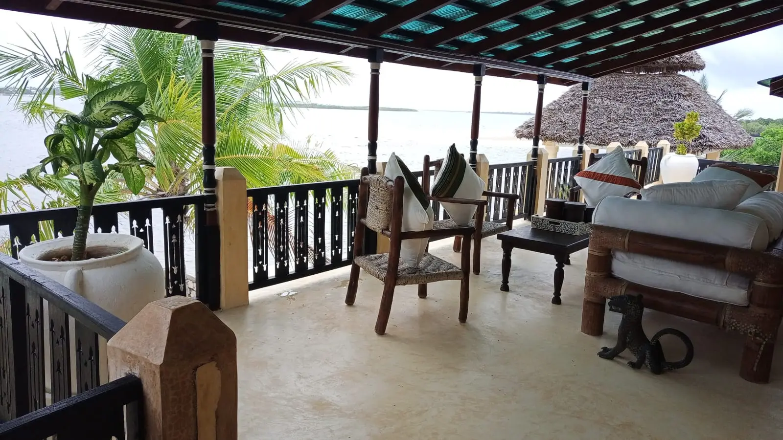 Covered terrace with ocean view and traditional furniture