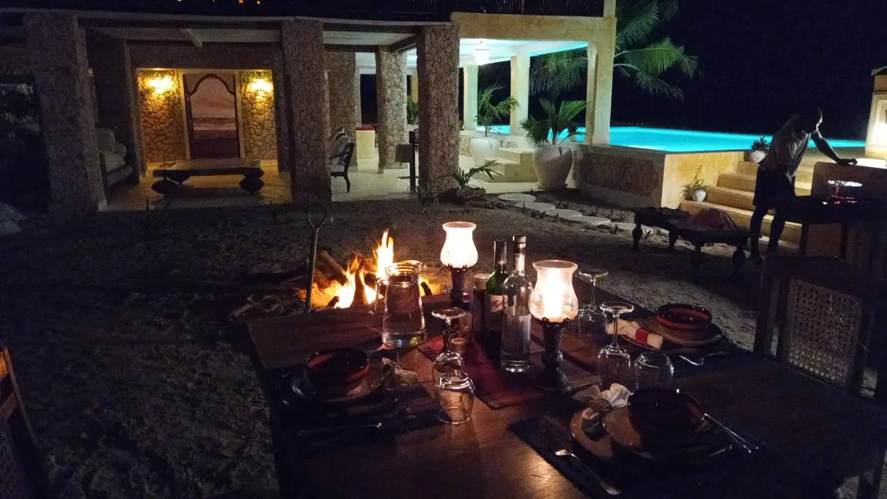 Evening dining setup on terrace with ocean view