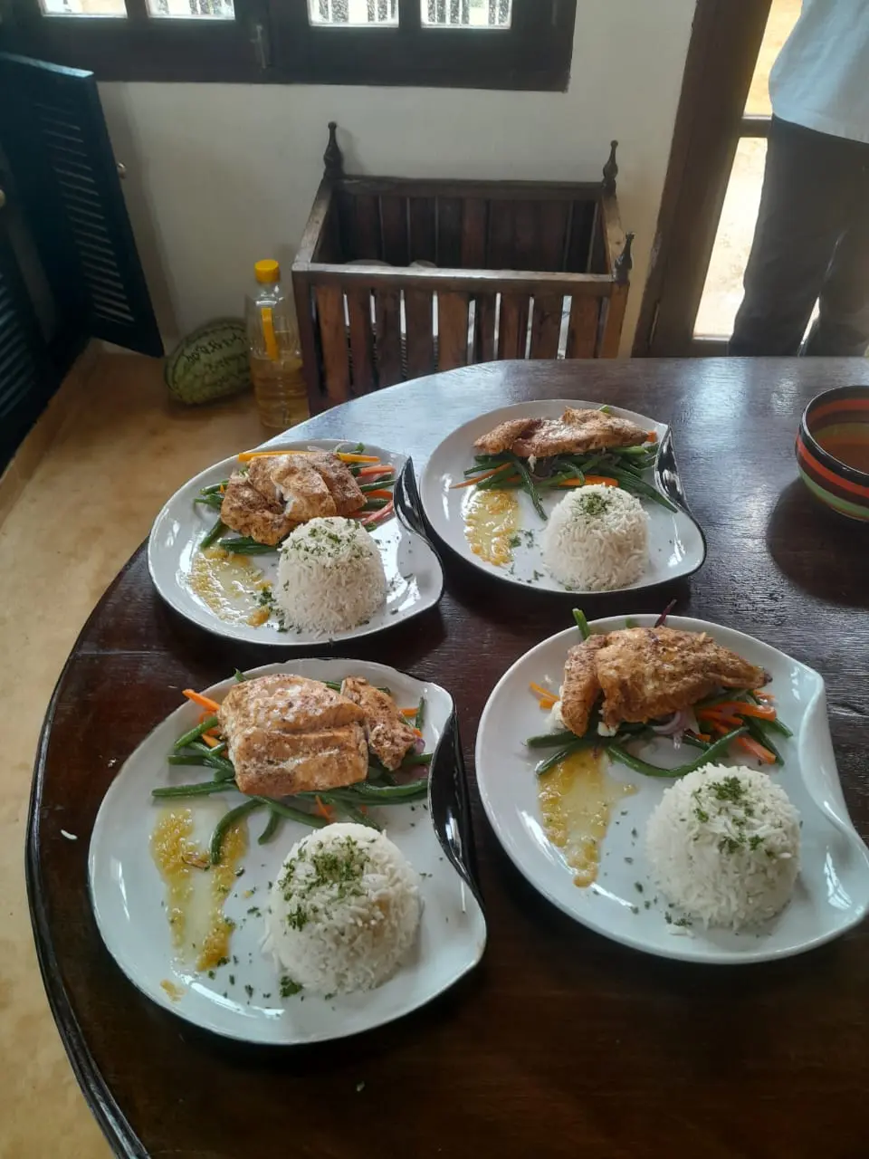 Gourmet meal presentation with fresh fish, rice and vegetables
