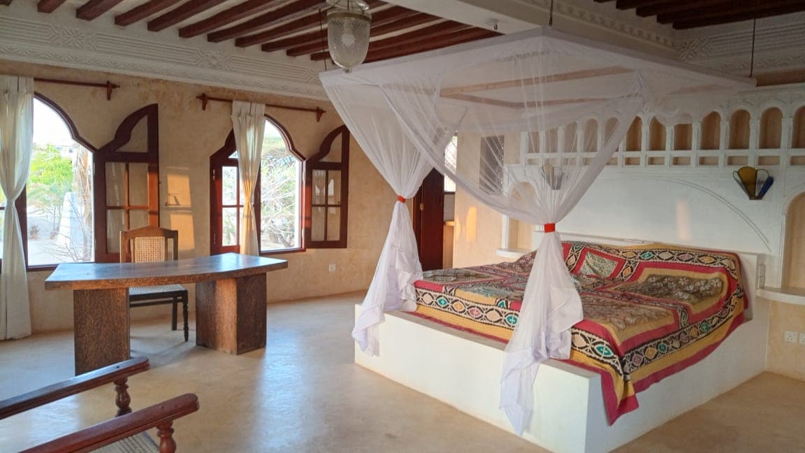 Bedroom interior with ocean view in Little Red Moon House