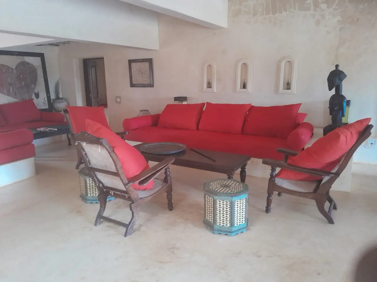 Main living room interior with red furniture and traditional architecture