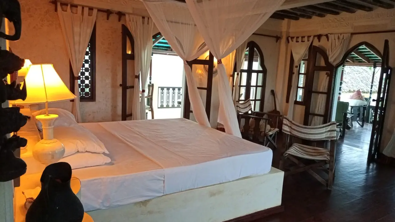 Master bedroom with four-poster bed and ocean view