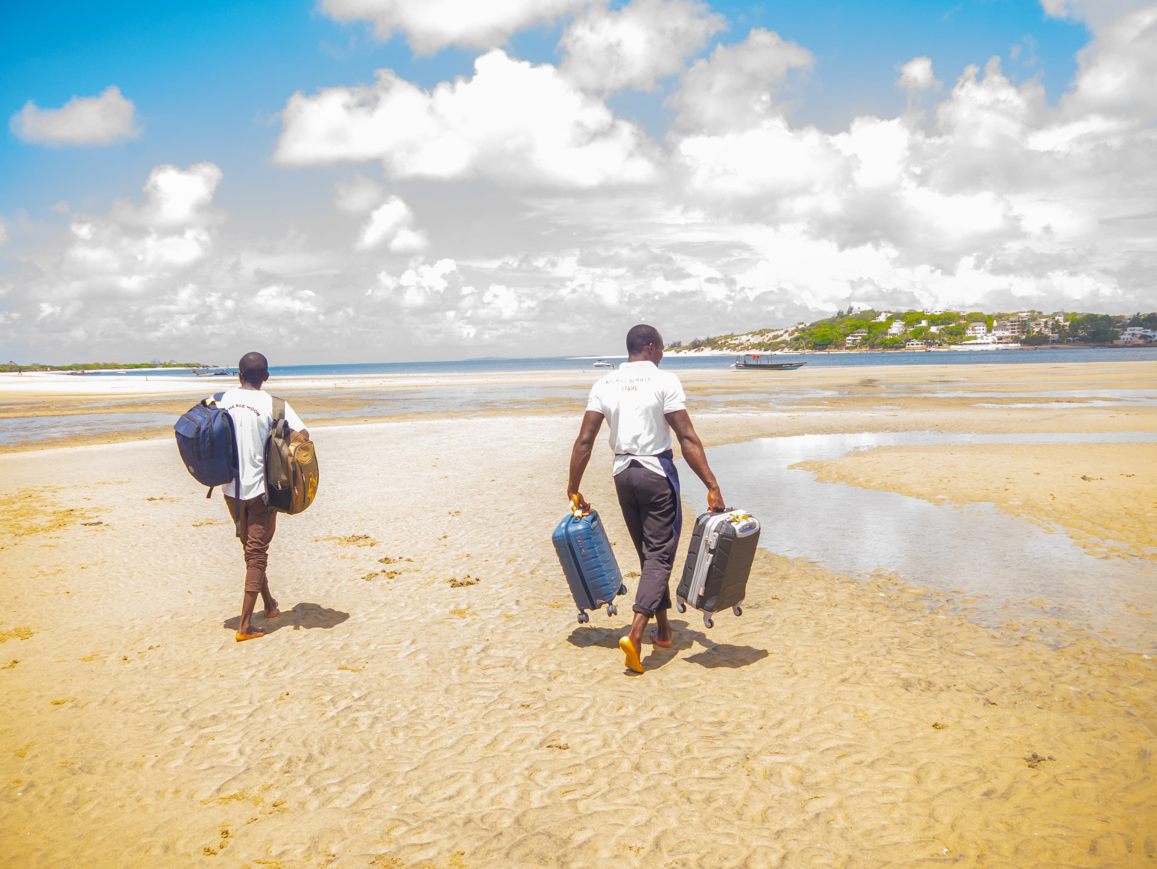 Staff carrying luggage to the boat for guests
